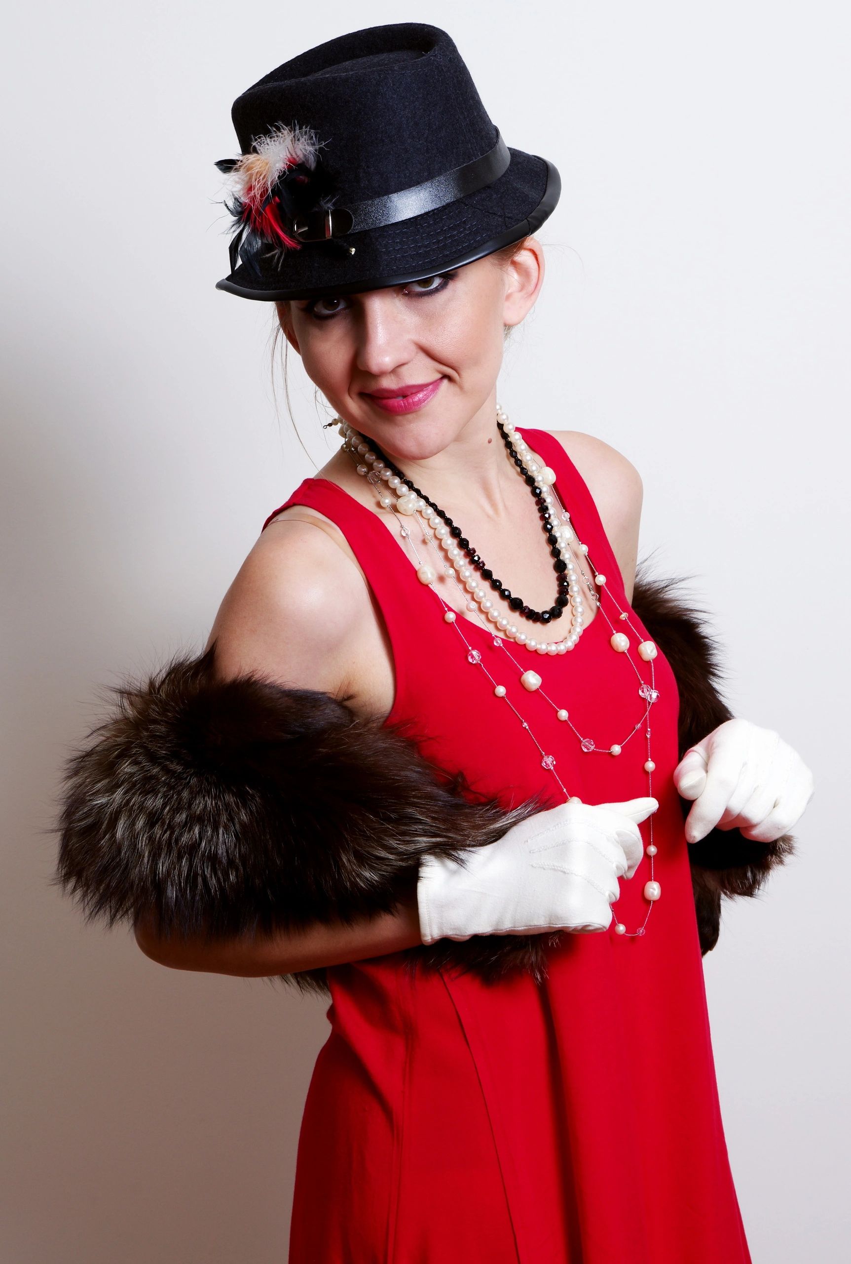 Confident woman in retro style clothing against a gray background